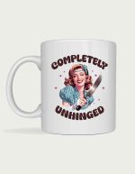Retro housewife mug - smiling vintage pinup woman holding a knife with the text Completely Unhinged