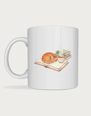 Book lover mug with a watercolour ginger cat curled up asleep on an open book next to a cup of tea and a stack of books, on a white ceramic mug