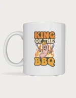 Dad mug - crowned cartoon sausage holding tongs with King of the BBQ lettering printed on a white ceramic mug