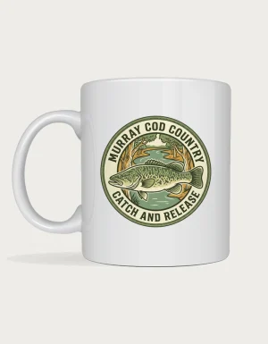 Murray cod mug with a round vintage badge of a mottled green cod, river and gum trees reading Murray Cod Country Catch and Release on a white ceramic mug