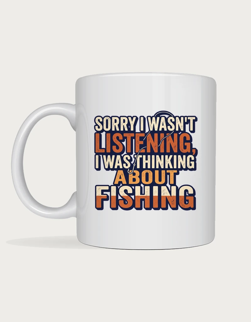 Funny fishing mug reading Sorry I Wasn't Listening, I Was Thinking About Fishing in bold cream and orange lettering on a white ceramic mug