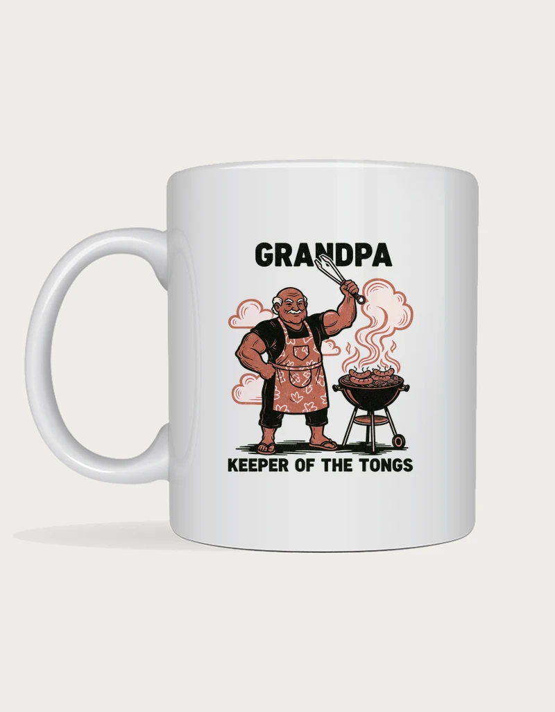 Funny grandpa gifts - linocut grandpa holding BBQ tongs beside a barbecue with sausages, Keeper of the Tongs, on a white ceramic mug