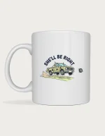 She'll be right mug: Cartoon ute held together with rope and tape bouncing down a dirt road, a hubcap flying off, under the words She'll Be Right