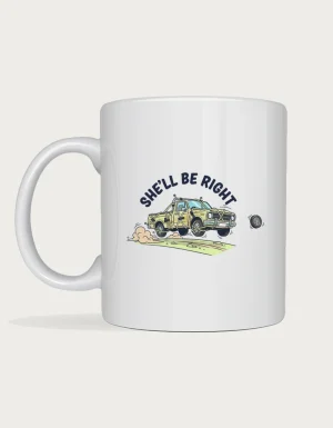 She'll be right mug: Cartoon ute held together with rope and tape bouncing down a dirt road, a hubcap flying off, under the words She'll Be Right