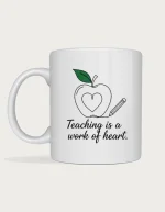 Teacher appreciation gift mug with line art of an apple with a heart inside and a pencil, above the words Teaching is a work of heart, on a white ceramic mug